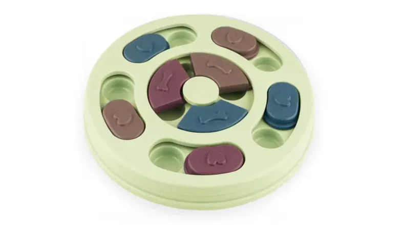 A light green circular pet puzzle toy with several compartments for food. A light green circular pet puzzle toy with several compartments for food.