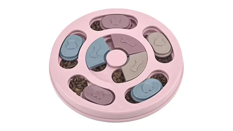 A light pink circular pet puzzle toy with several compartments for food. A light pink circular pet puzzle toy with several compartments for food.