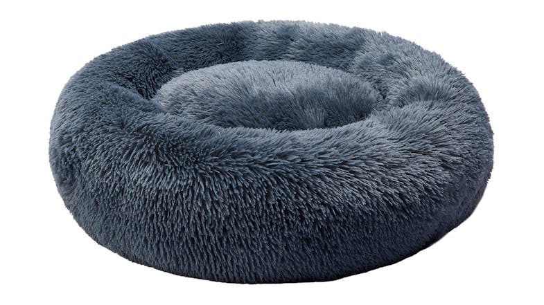 A blue, round, plush pet bed with a soft, fluffy texture. A blue, round, plush pet bed with a soft, fluffy texture.
