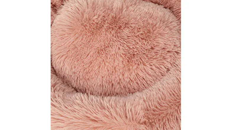 A round, plush, pink pet bed with a soft, fluffy texture. A round, plush, pink pet bed with a soft, fluffy texture.