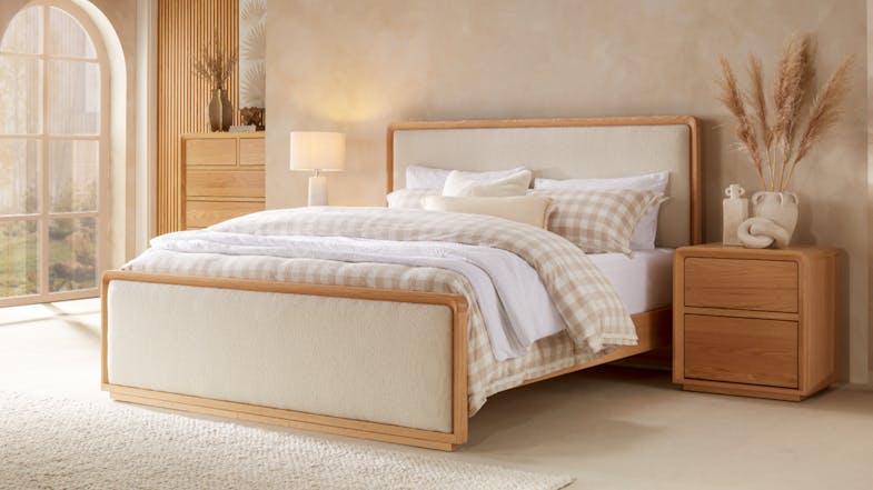 A view of a fully styled bedroom featuring the Omaha King Upholstered Bed Frame at the centre, surrounded by matching wooden furniture and decor. A view of a fully styled bedroom featuring the Omaha King Upholstered Bed Frame at the centre, surrounded by matching wooden furniture and decor.