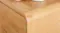 A close-up view of the bedside table’s smooth, rounded corner. A close-up view of the bedside table’s smooth, rounded corner.