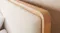 A close-up view of the Omaha headboard with a light wood frame and textured cream fabric. A close-up view of the Omaha headboard with a light wood frame and textured cream fabric.