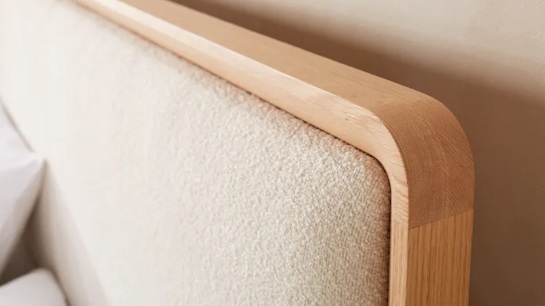 A close-up view of the Omaha headboard with a light wood frame and textured cream fabric. A close-up view of the Omaha headboard with a light wood frame and textured cream fabric.