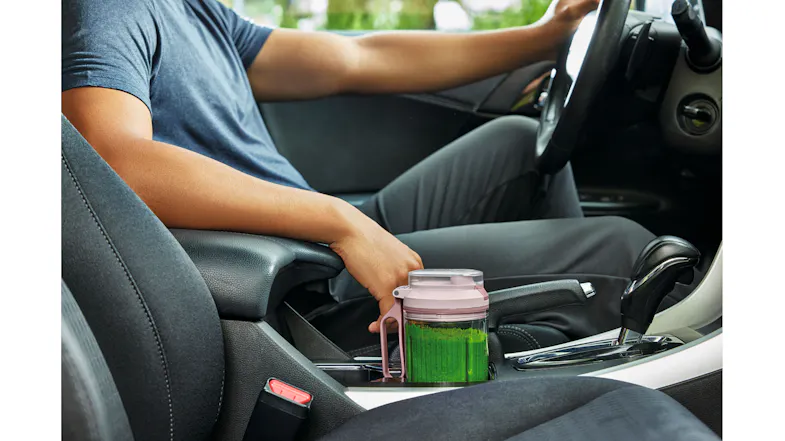 A view of a car with the blender situated on the cup holder A view of a car with the blender situated on the cup holder