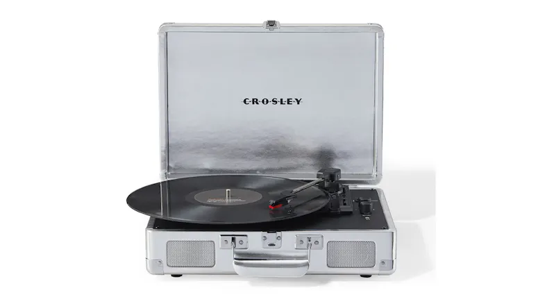A portable Crosley turntable with lid open and tonearm positioned over a spinning vinyl record. A portable Crosley turntable with lid open and tonearm positioned over a spinning vinyl record.
