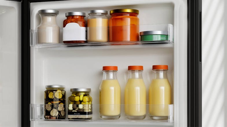 Stocked Haier fridge with drinks, condiments, and containers with food Stocked Haier fridge with drinks, condiments, and containers with food