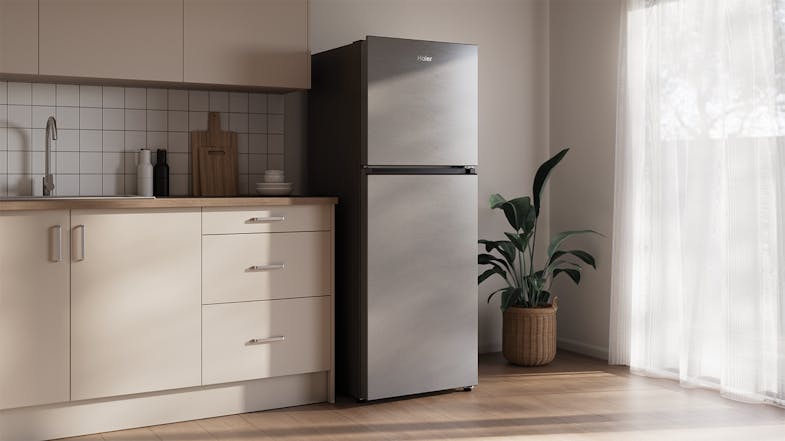 A modern, silver fridge freezer in a minimalist kitchen setting A modern, silver fridge freezer in a minimalist kitchen setting