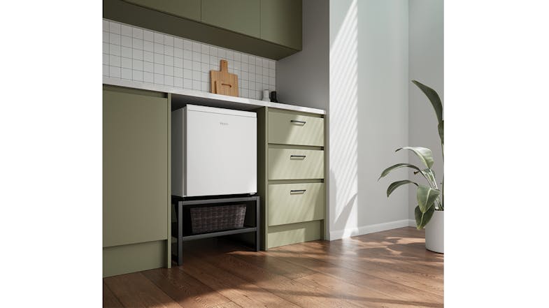 Compact fridge positioned under green cabinetry Compact fridge positioned under green cabinetry