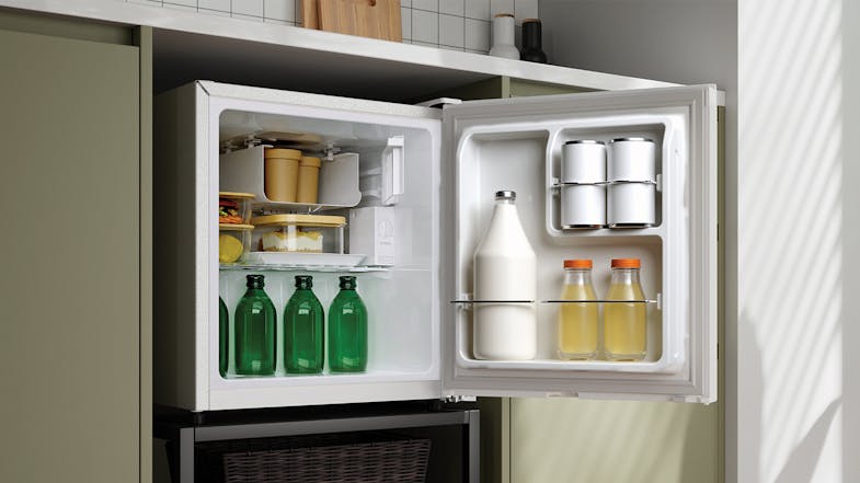Stocked Haier fridge with drinks, condiments, and containers with food Stocked Haier fridge with drinks, condiments, and containers with food