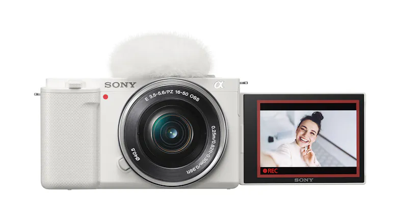 A front view of a mirrorless camera with a flip screen showing recording in progress A front view of a mirrorless camera with a flip screen showing recording in progress