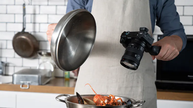 Person filming a dish in the kitchen Person filming a dish in the kitchen