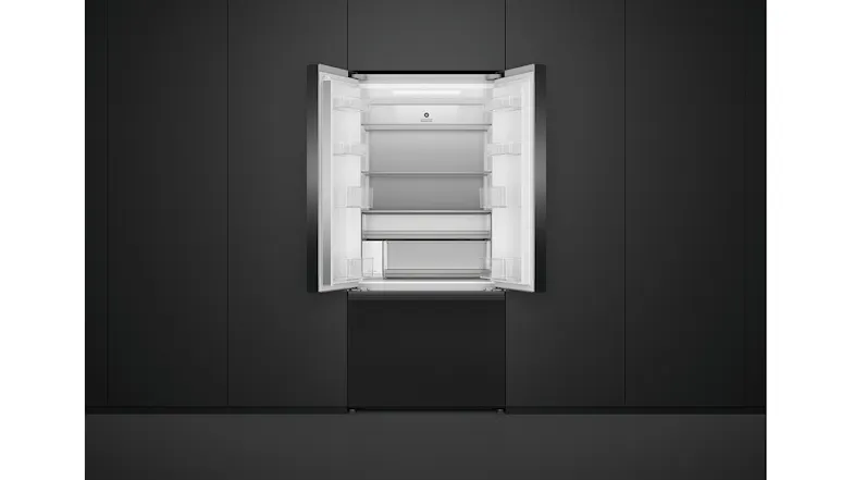 Open black French door fridge with empty shelves, positioned in a black cabinet Open black French door fridge with empty shelves, positioned in a black cabinet