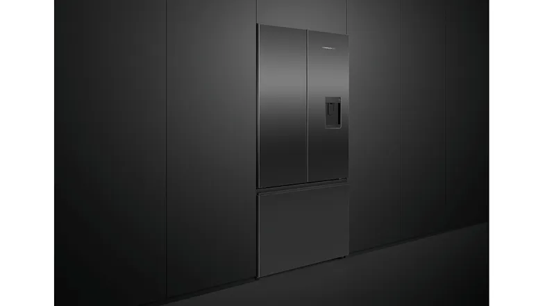 Closed black French door fridge with a dispenser positioned in a black cabinet Closed black French door fridge with a dispenser positioned in a black cabinet