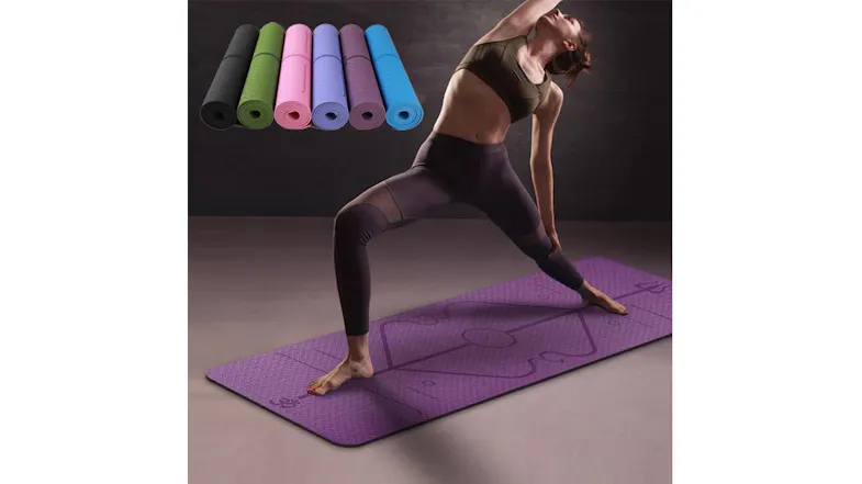 A person poses on a mat with rolled mats above A person poses on a mat with rolled mats above
