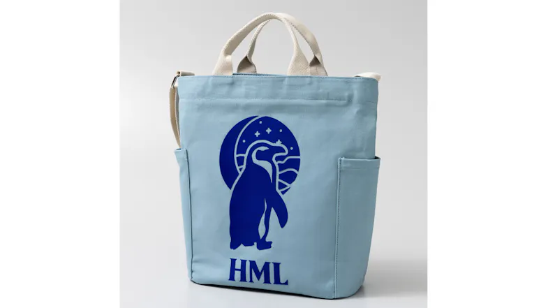 A blue tote with a penguin and moon graphic design A blue tote with a penguin and moon graphic design