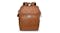 A brown leather backpack with a top flap, a handle, and a front pocket A brown leather backpack with a top flap, a handle, and a front pocket