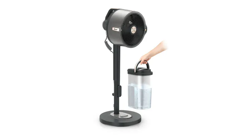 A pedestal fan and a person holding the water tank A pedestal fan and a person holding the water tank