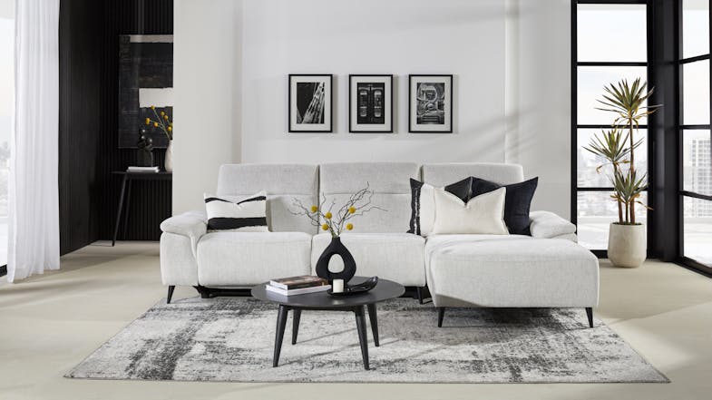 Front view of a three-seater electric reclining sofa in beige upholstery, with a right-side chaise Front view of a three-seater electric reclining sofa in beige upholstery, with a right-side chaise