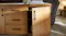A close-up view of the table's cabinet door slightly open A close-up view of the table's cabinet door slightly open