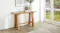 A wide view of the hall table, beautifully displayed in a light and inviting entryway A wide view of the hall table, beautifully displayed in a light and inviting entryway