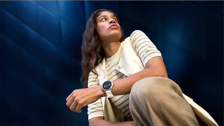 A person in a beige outfit wearing a Garmin Venu 4 Smartwatch A person in a beige outfit wearing a Garmin Venu 4 Smartwatch