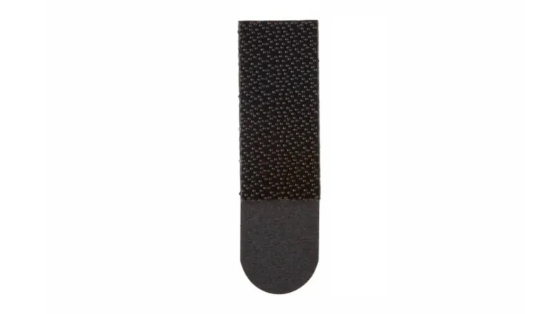 Front-facing single black Command Strip with a textured surface Front-facing single black Command Strip with a textured surface