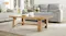 A view of a light and inviting living room with the coffee table beautifully displayed on the centre A view of a light and inviting living room with the coffee table beautifully displayed on the centre
