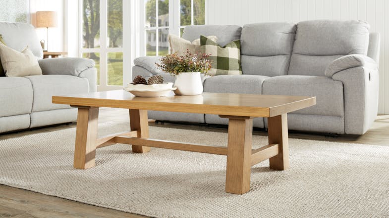 A view of a light and inviting living room with the coffee table beautifully displayed on the centre A view of a light and inviting living room with the coffee table beautifully displayed on the centre