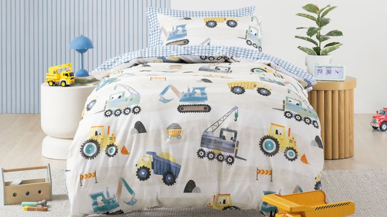 A duvet cover set in a cosy room showing diggers, bulldozers, yellow trucks, cranes, and more A duvet cover set in a cosy room showing diggers, bulldozers, yellow trucks, cranes, and more