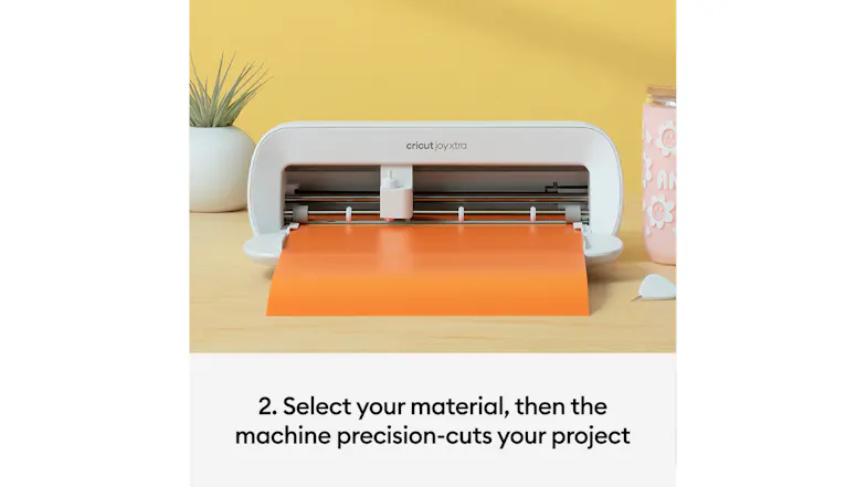 Crafting machine cutting orange material on a desk with instructional text overlay Crafting machine cutting orange material on a desk with instructional text overlay