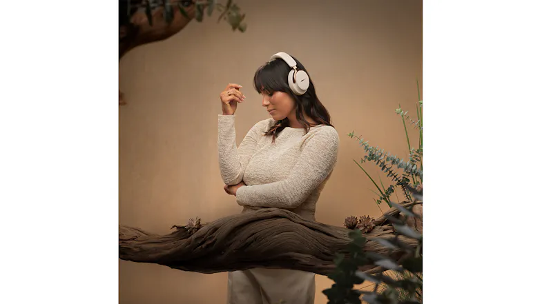 A person looking at the ground while wearing headphones A person looking at the ground while wearing headphones