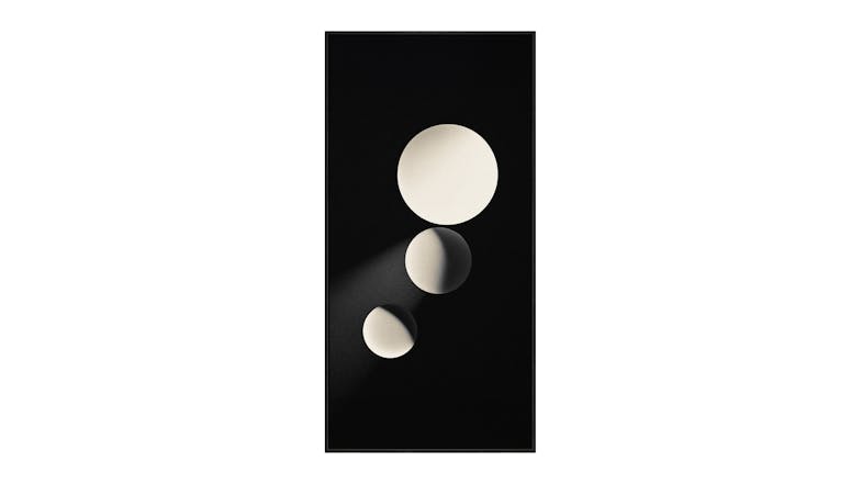 An abstract artwork featuring three white spheres of varying sizes aligned vertically against a black background, with light casting shadows on them. An abstract artwork featuring three white spheres of varying sizes aligned vertically against a black background, with light casting shadows on them.