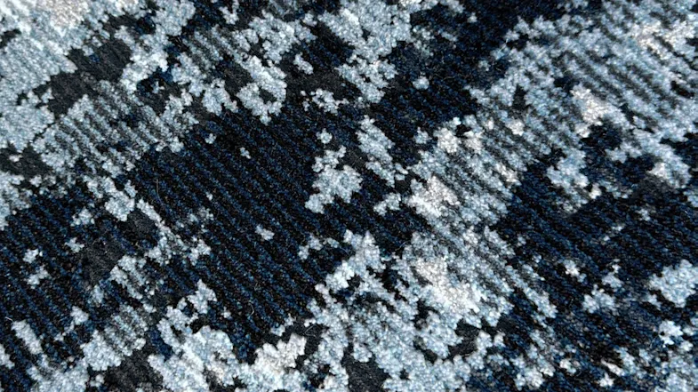 Texture detail of blue and grey abstract patterned rug. Texture detail of blue and grey abstract patterned rug.