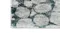 Corner view of blue rug with grey and white hexagonal pattern. Corner view of blue rug with grey and white hexagonal pattern.