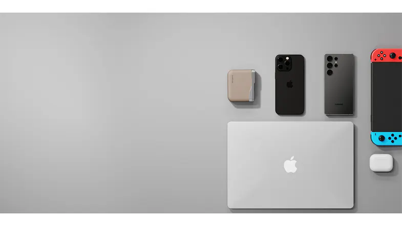 Flat lay of a MacBook, two smartphones, a Nintendo Switch, AirPods, and a small charging device. Flat lay of a MacBook, two smartphones, a Nintendo Switch, AirPods, and a small charging device.