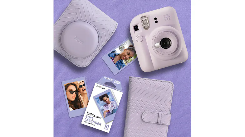A camera beside a case, an album, spray art film, and printed photos A camera beside a case, an album, spray art film, and printed photos