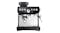 A manual espresso machine with coffee grounds being dispensed directly into the portafilter A manual espresso machine with coffee grounds being dispensed directly into the portafilter