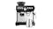 A black espresso machine, featuring the bean hopper, control panel, pressure gauge, and a milk jug A black espresso machine, featuring the bean hopper, control panel, pressure gauge, and a milk jug