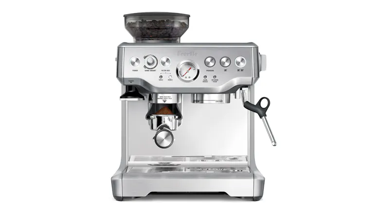 A manual espresso machine with coffee grounds being dispensed directly into the portafilter A manual espresso machine with coffee grounds being dispensed directly into the portafilter