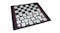 Pieces of black and white checkers arranged on a square board with a black border and red stitching Pieces of black and white checkers arranged on a square board with a black border and red stitching