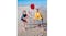 Two kids playing Disk Duel on a sandy beach with a blue pole, red disc, and a bottle in mid-air Two kids playing Disk Duel on a sandy beach with a blue pole, red disc, and a bottle in mid-air