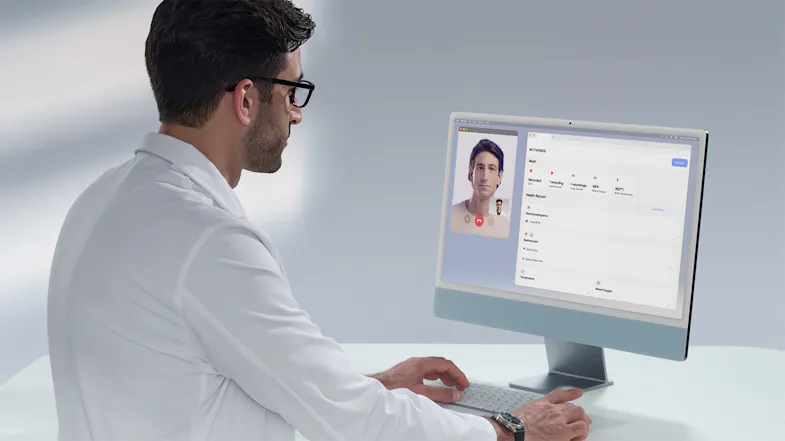 Doctor viewing a patient's health data and a video call screen during a telehealth consultation Doctor viewing a patient's health data and a video call screen during a telehealth consultation