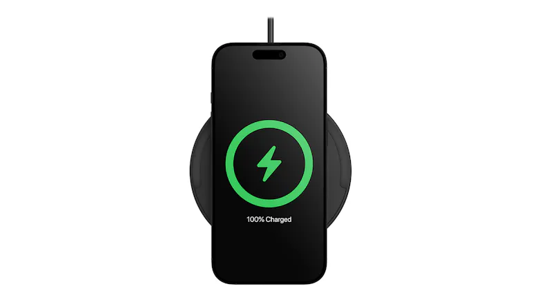 Smartphone on a wireless charging pad showing 100% charged status Smartphone on a wireless charging pad showing 100% charged status