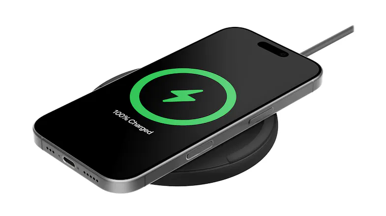 Smartphone on a Belkin pad showing 100% charged icon Smartphone on a Belkin pad showing 100% charged icon