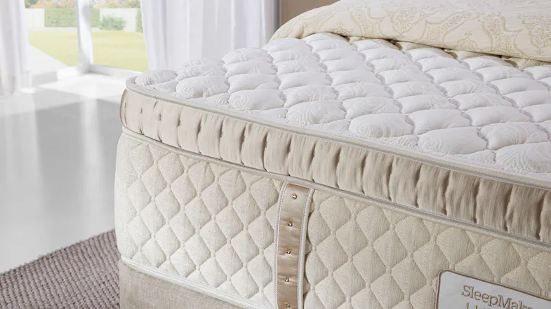 Couture Firm Super King Mattress, close up of mattress end with strip of diamantes. Couture Firm Super King Mattress, close up of mattress end with strip of diamantes.