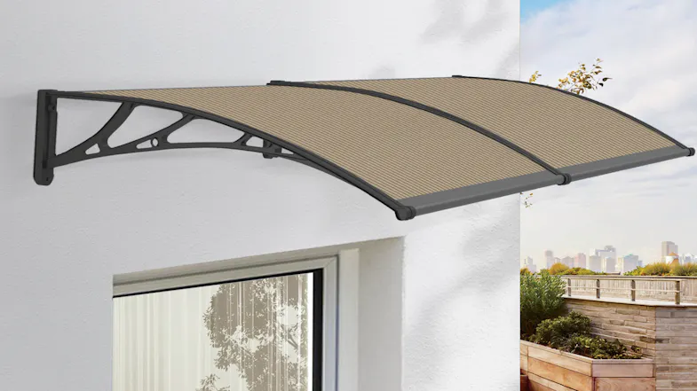 An awning installed above a window on a white wall with outdoor view An awning installed above a window on a white wall with outdoor view