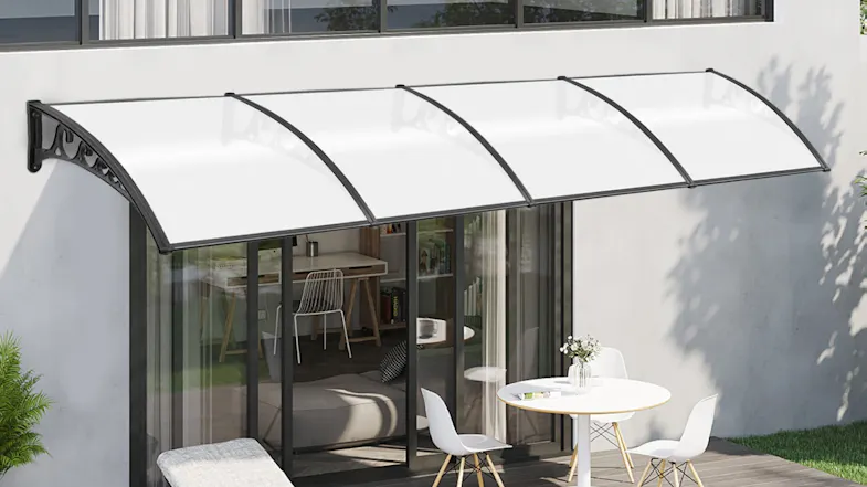 Outdoor seating area under a sleek white awning attached to a two-story house Outdoor seating area under a sleek white awning attached to a two-story house