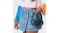 Person in a colourful crochet top and a denim skirt holding Skullcandy headphones Person in a colourful crochet top and a denim skirt holding Skullcandy headphones