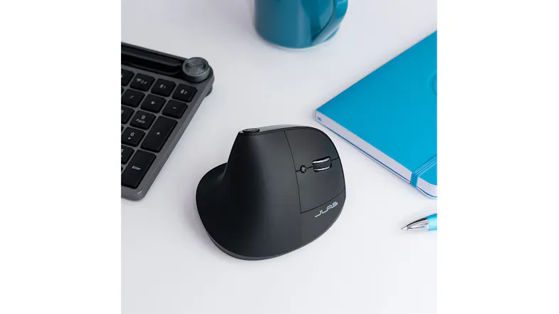Workspace setup with JLab mouse, keyboard, mug, and notebook Workspace setup with JLab mouse, keyboard, mug, and notebook